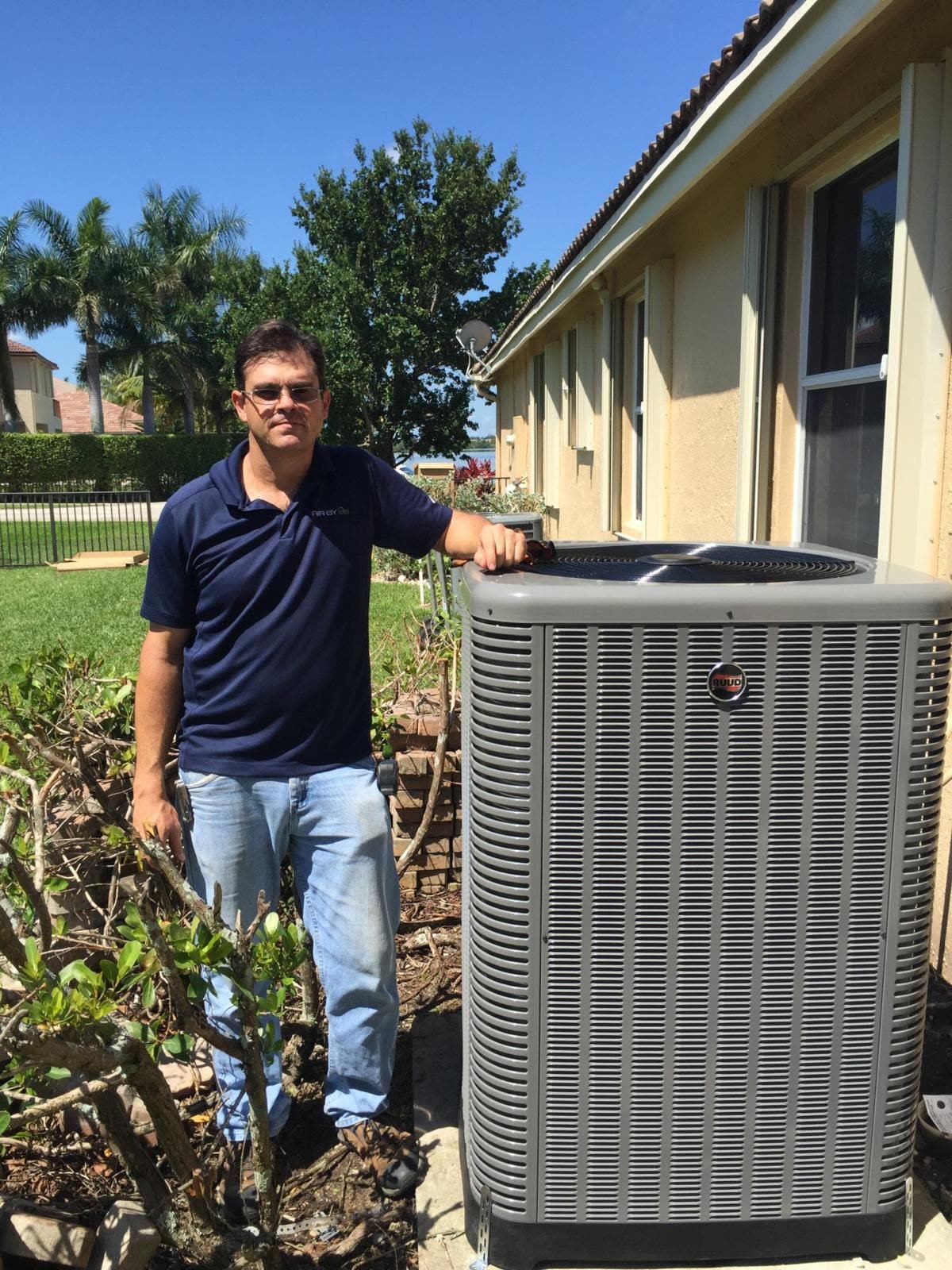 Technician checking an outdoor air conditioning unit with gauges